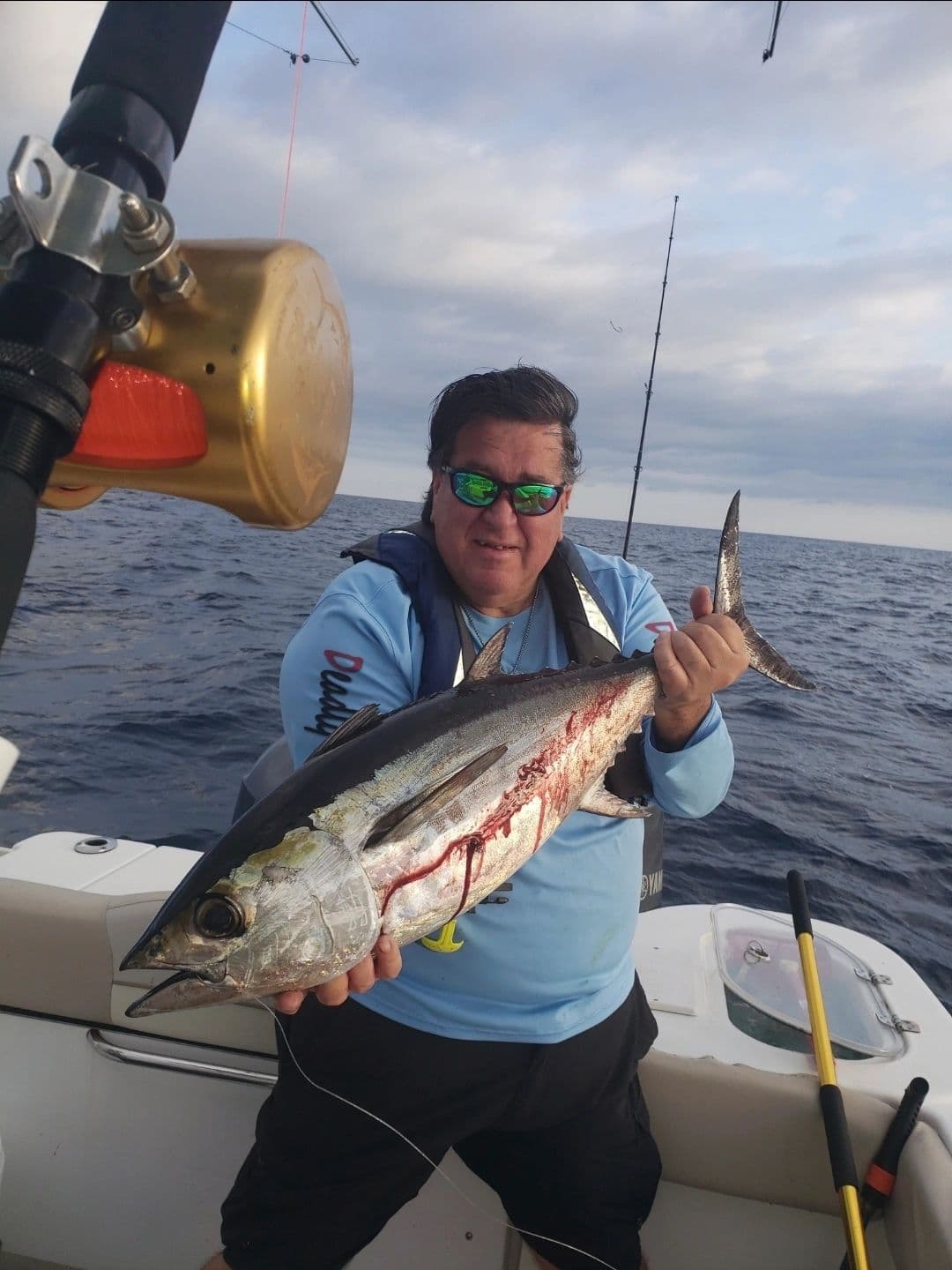 Angler holding a fresh catch on deck