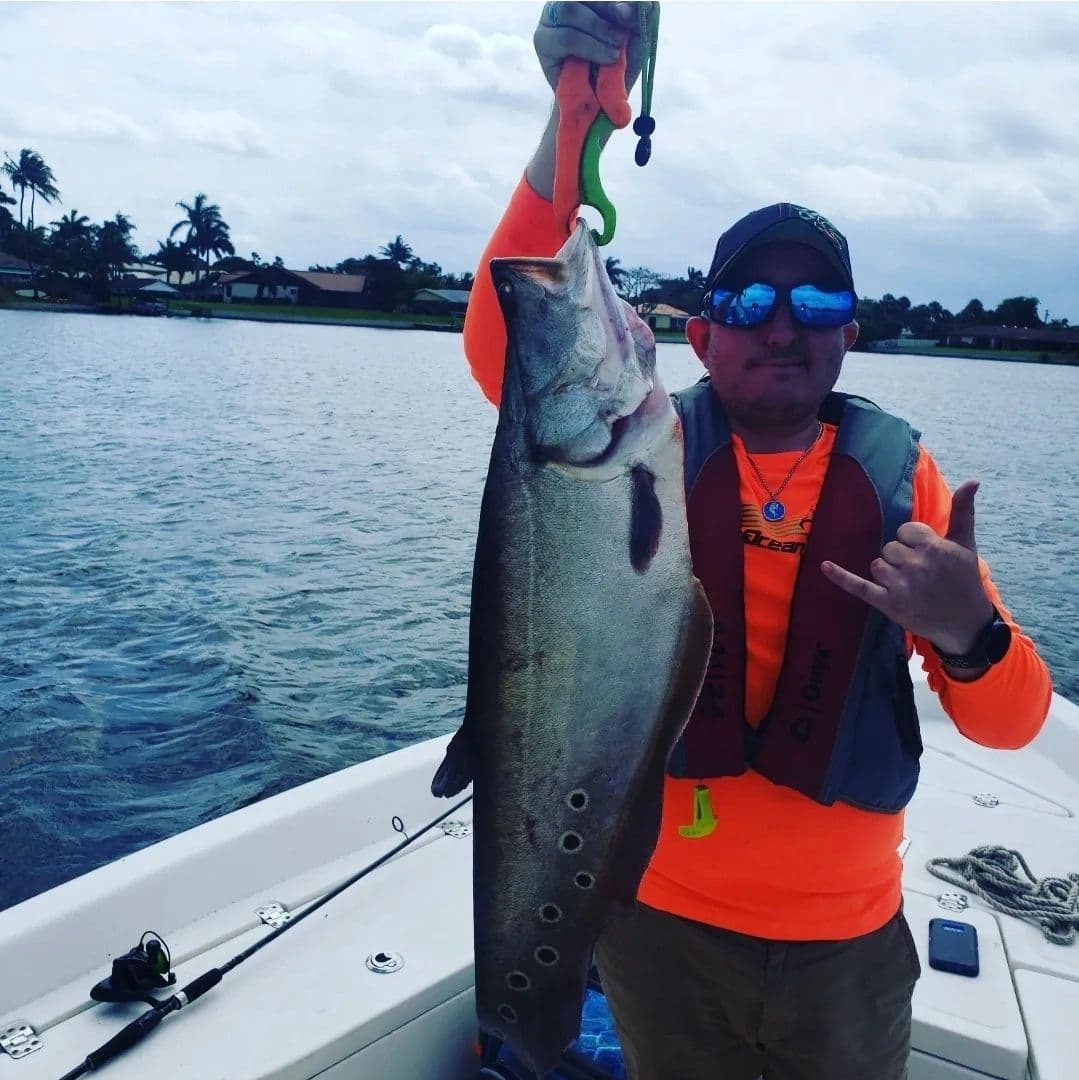 Angler holding a big catch dockside